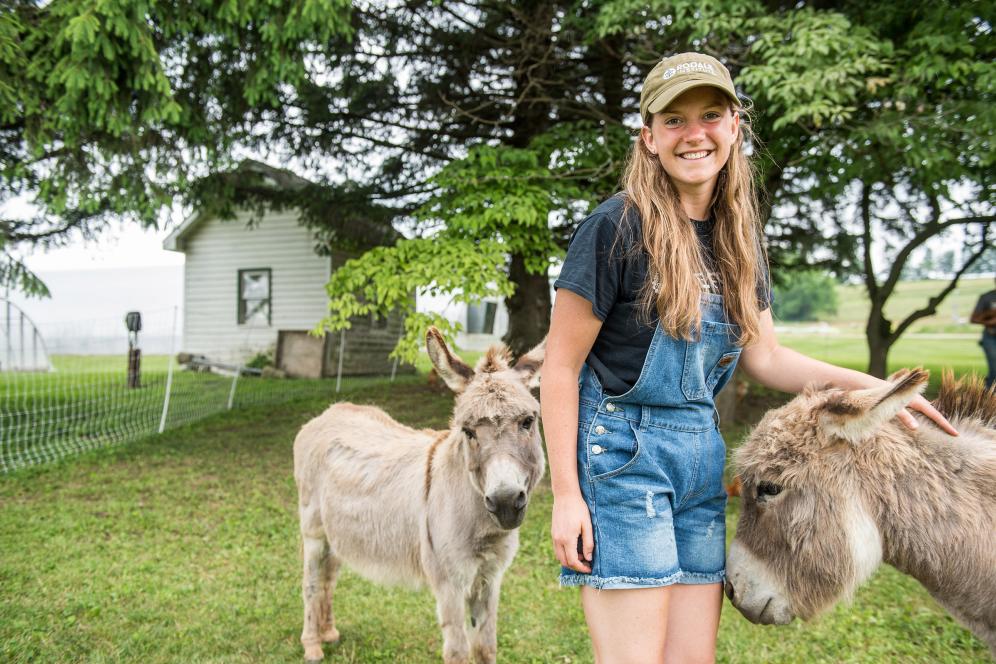 female student petting animals