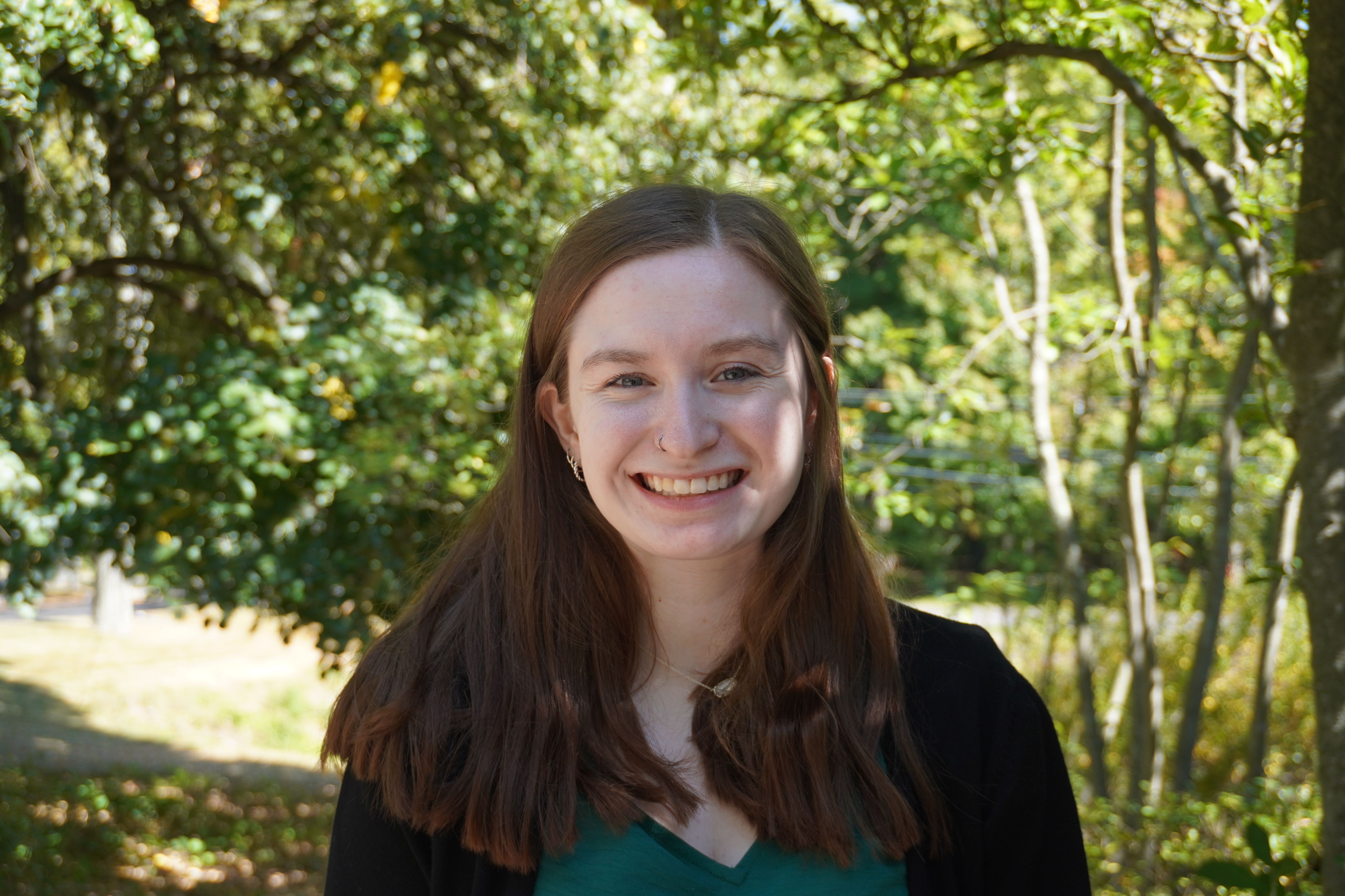 A headshot of Bella Primavera in front of the admissions cottage.