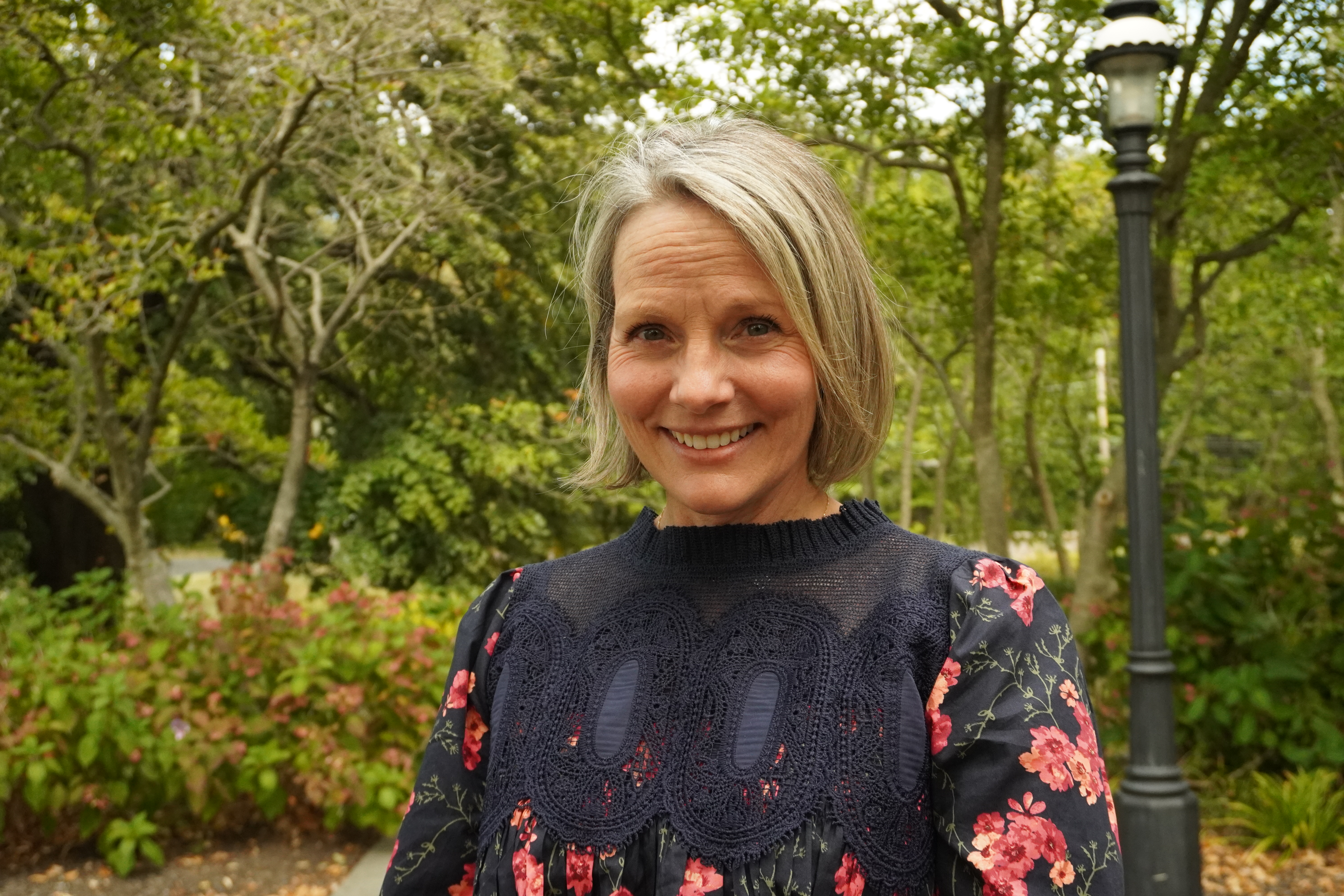 A headshot of Heather Aivazian in front of the admissions cottage. 