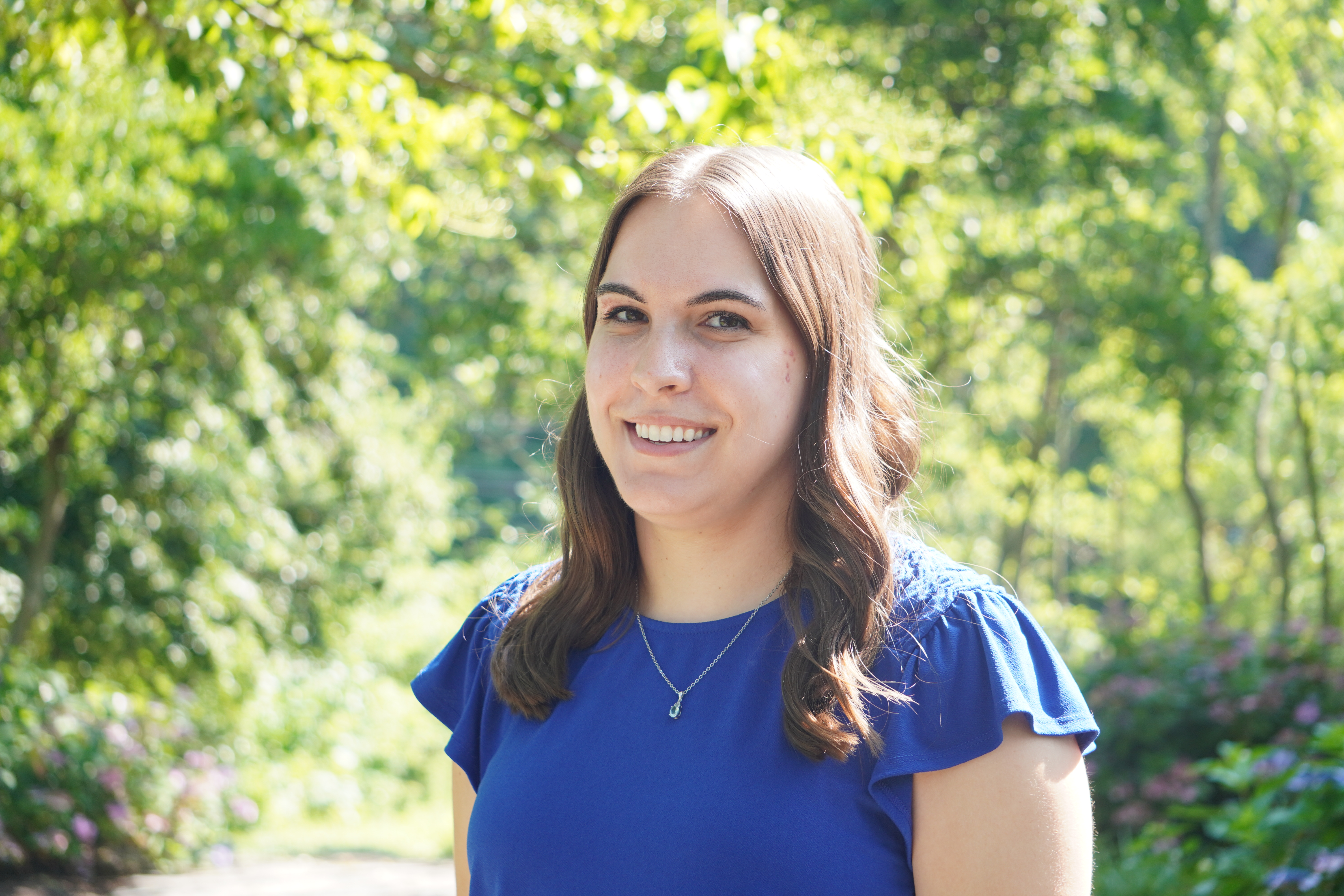 A headshot of Kim Pawlishyn in front of the admissions cottage.