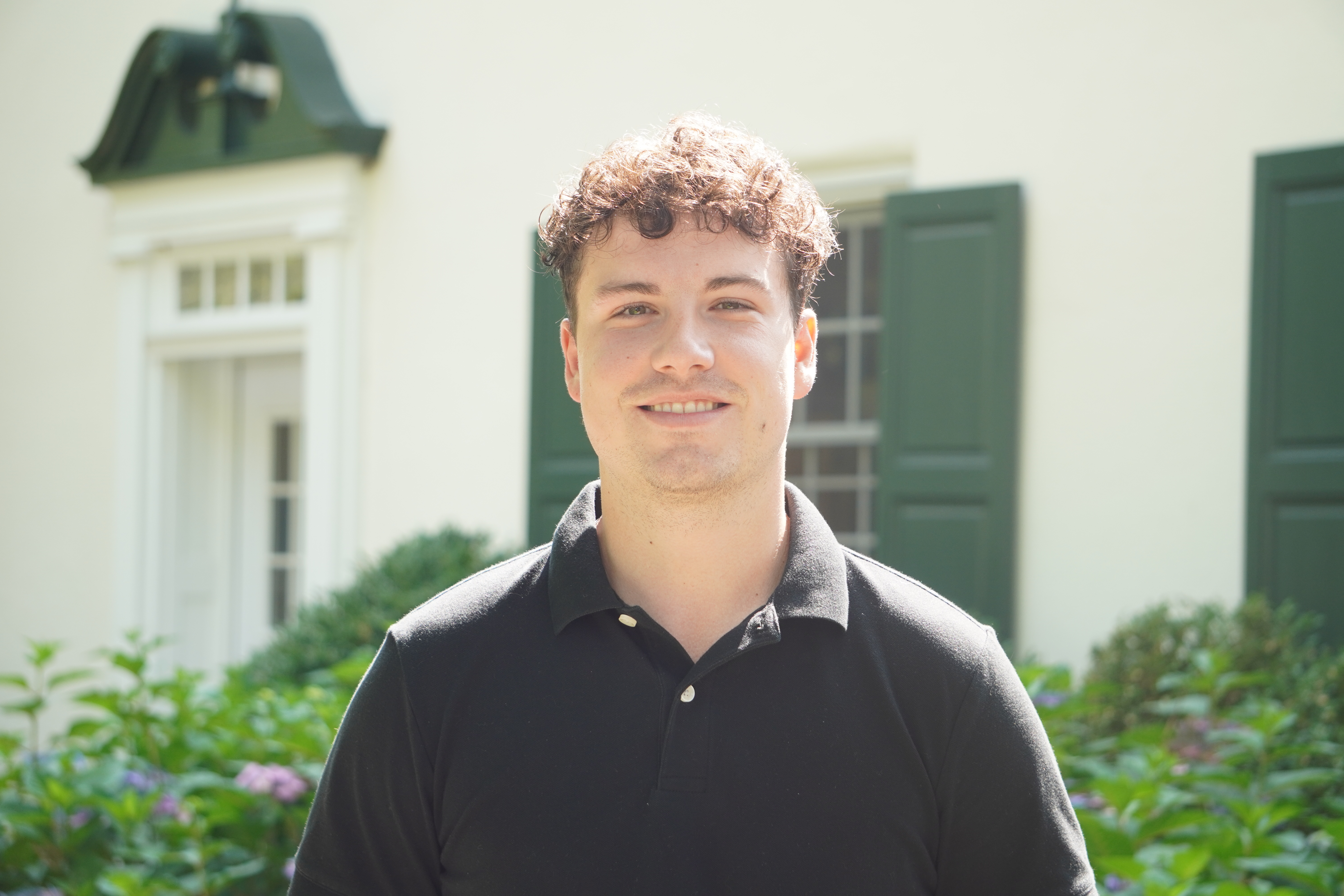 A headshot of Mitch Pinder standing outside of the admission cottage. 