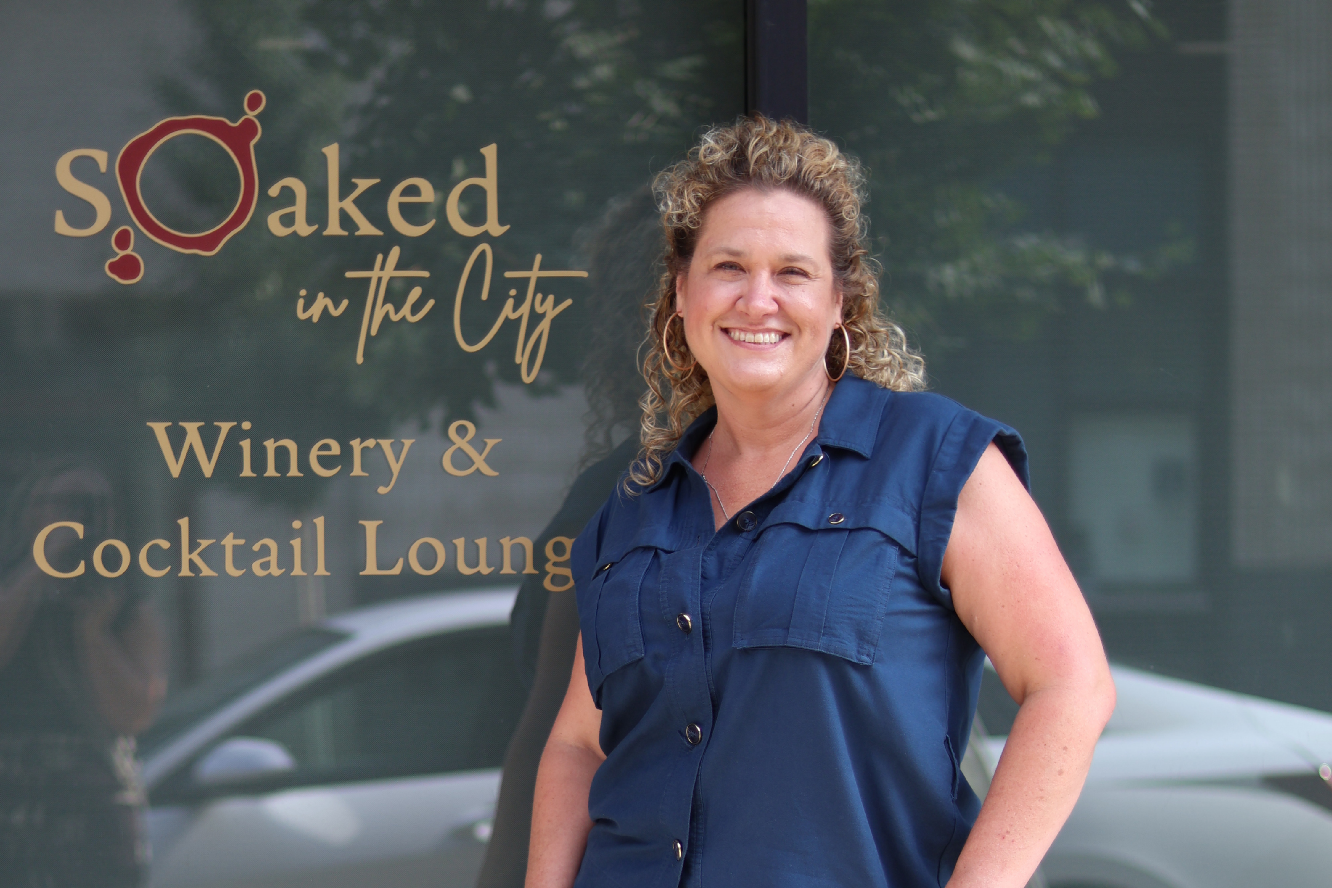 A photo of a food science alumna in front of her business.