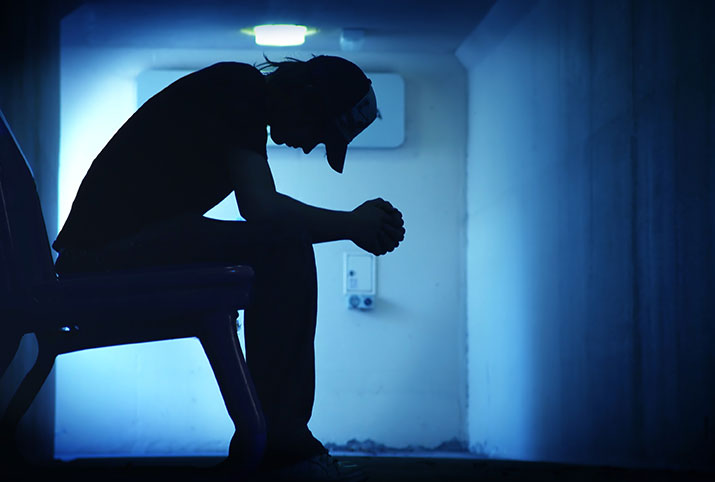 A teen sitting alone