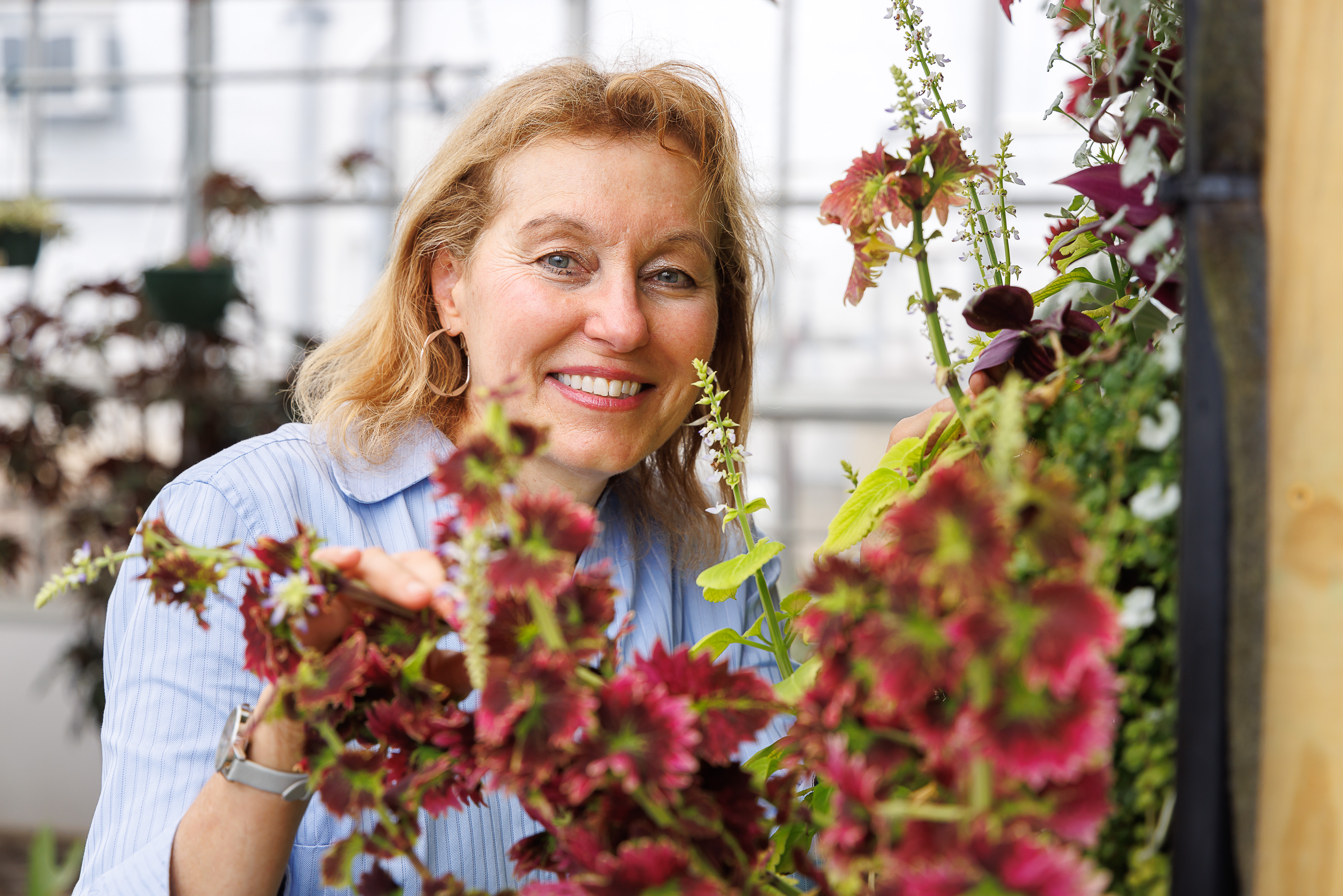 Dr. Jacqueline Ricotta smiling in the greenhouse.