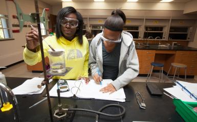 Two female lab partners working together.