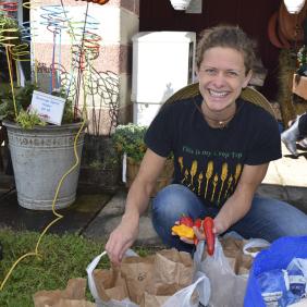 Dr. Sarah Dohle, assistant professor of plant science, outside in a field of plants.