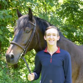 Ryan French standing with a horse