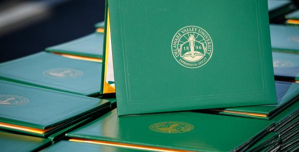 DelVal diploma covers stacked up at graduation