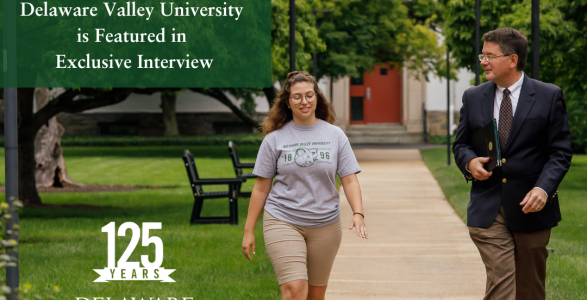 Dr.Ben is walking with a student on campus 