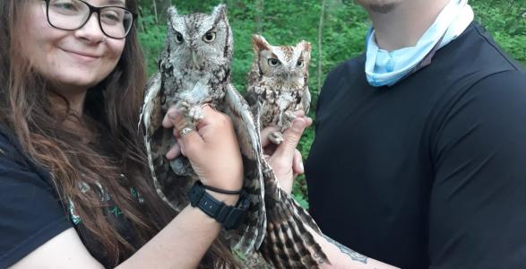 Jacob Miranda holding an owl with a classmate