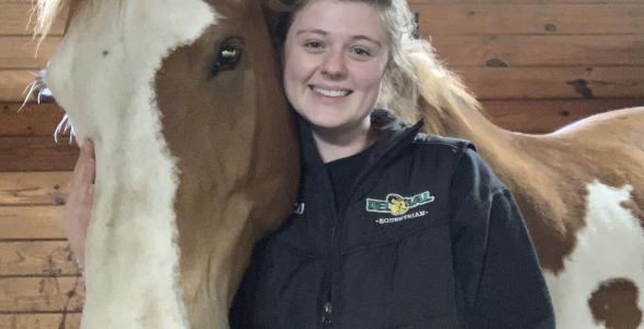 Madeleine poses with a horse. 