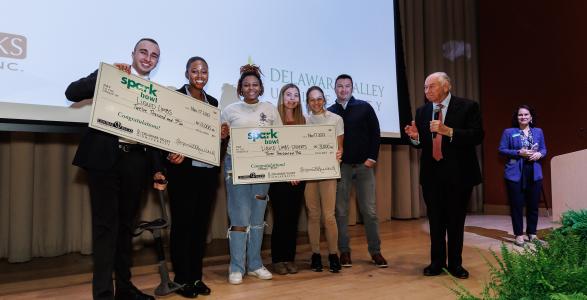 Spark Bowl Competition Finalists on Stage with Business Administration Student Consultants 