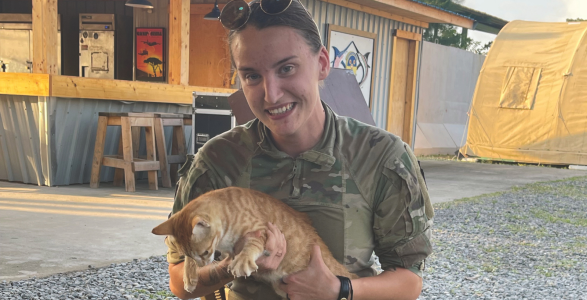 TJ in military gear holding a cat.