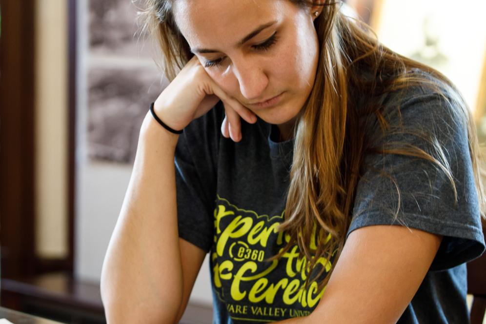 A female student studying resting her head against her hand