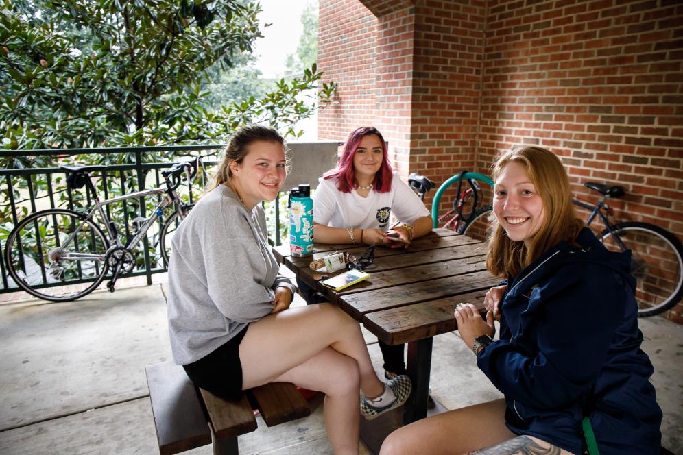 A group of students socializing around a table