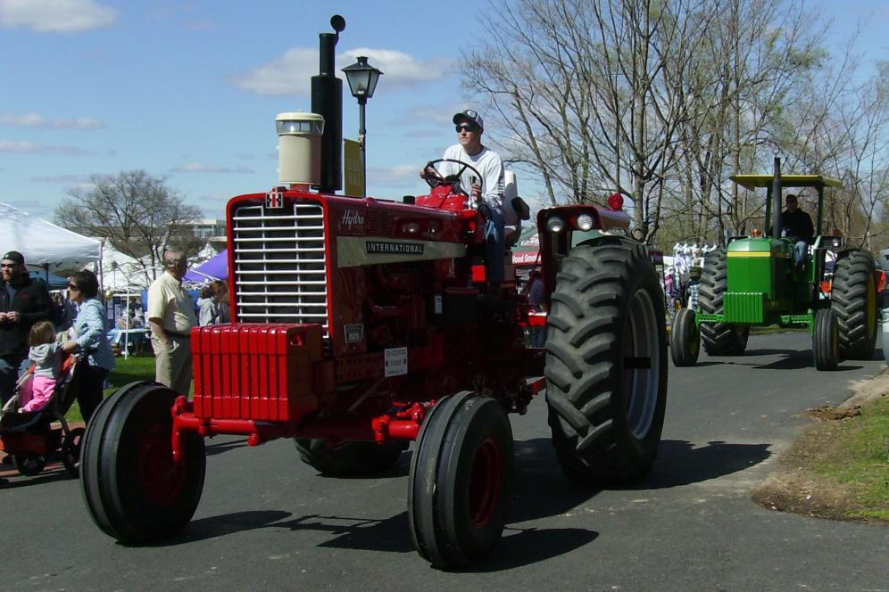 Red tractor driving at A-Day Festival.