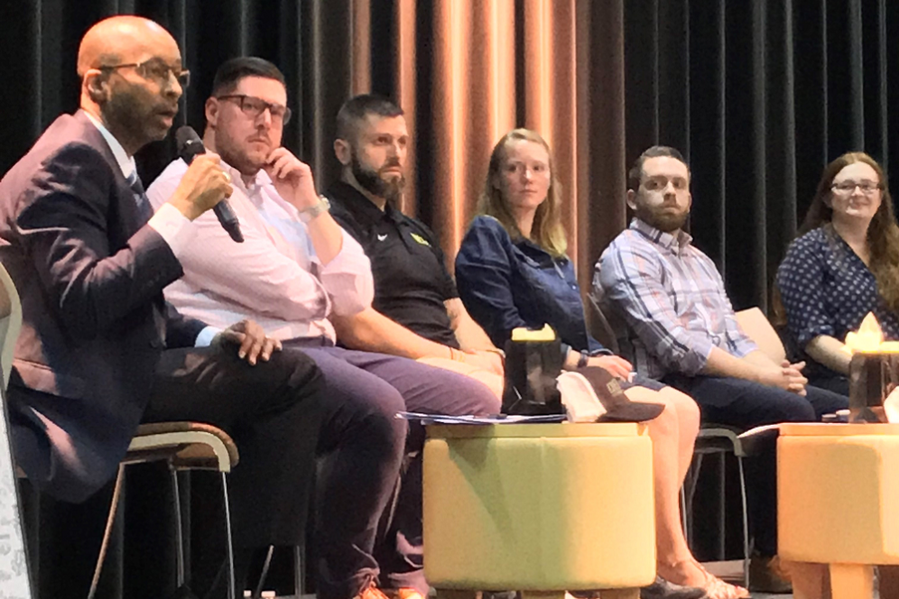 alumni sitting on stage panel