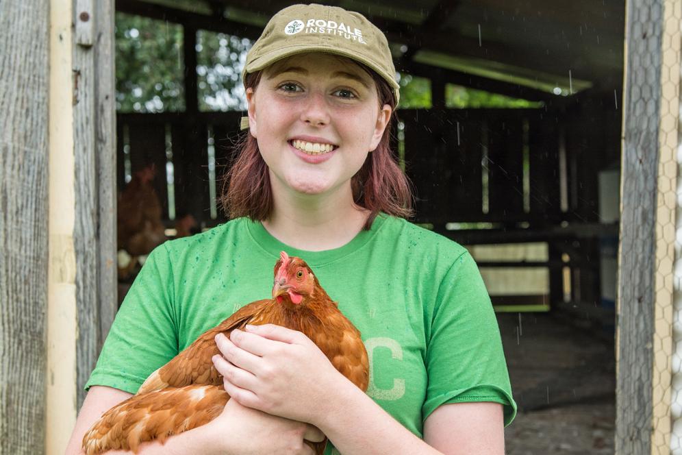 female student holding a chicken