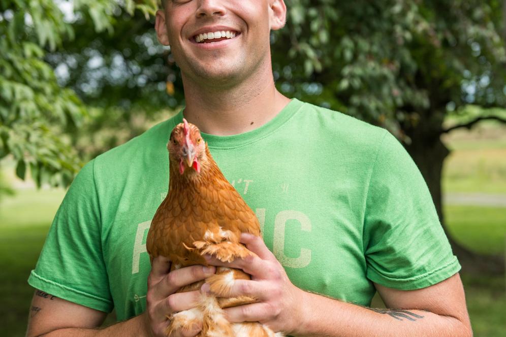 male student holding a chicken