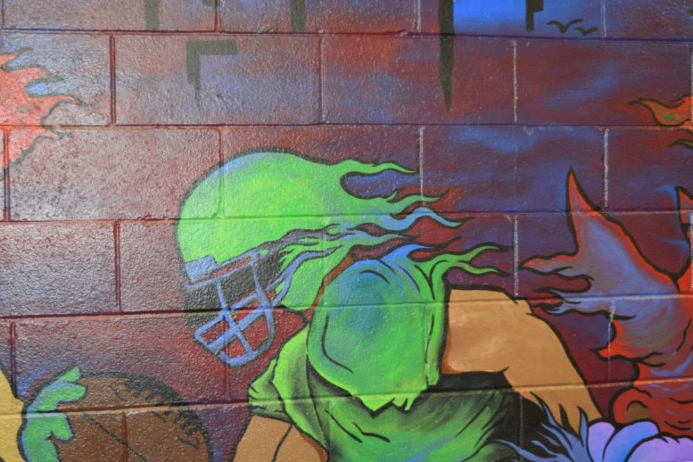 Football player portion of the full mural in the multicultural lounge