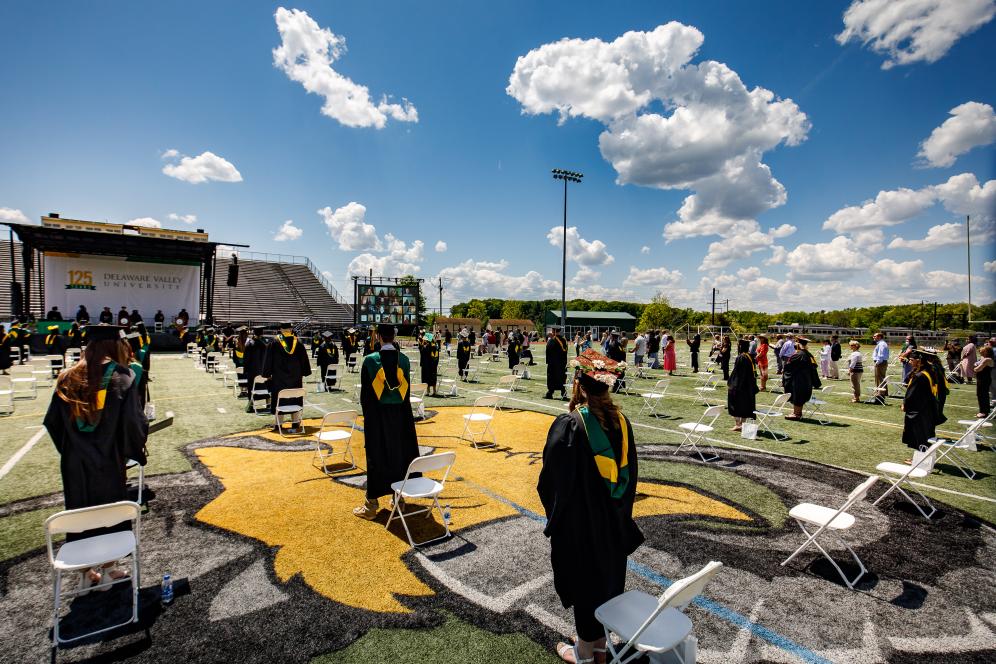 Graduates outside on the football field