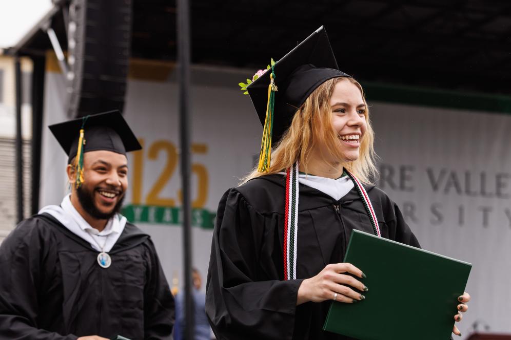 Graduates walk from the stage after receiving their diplomas.