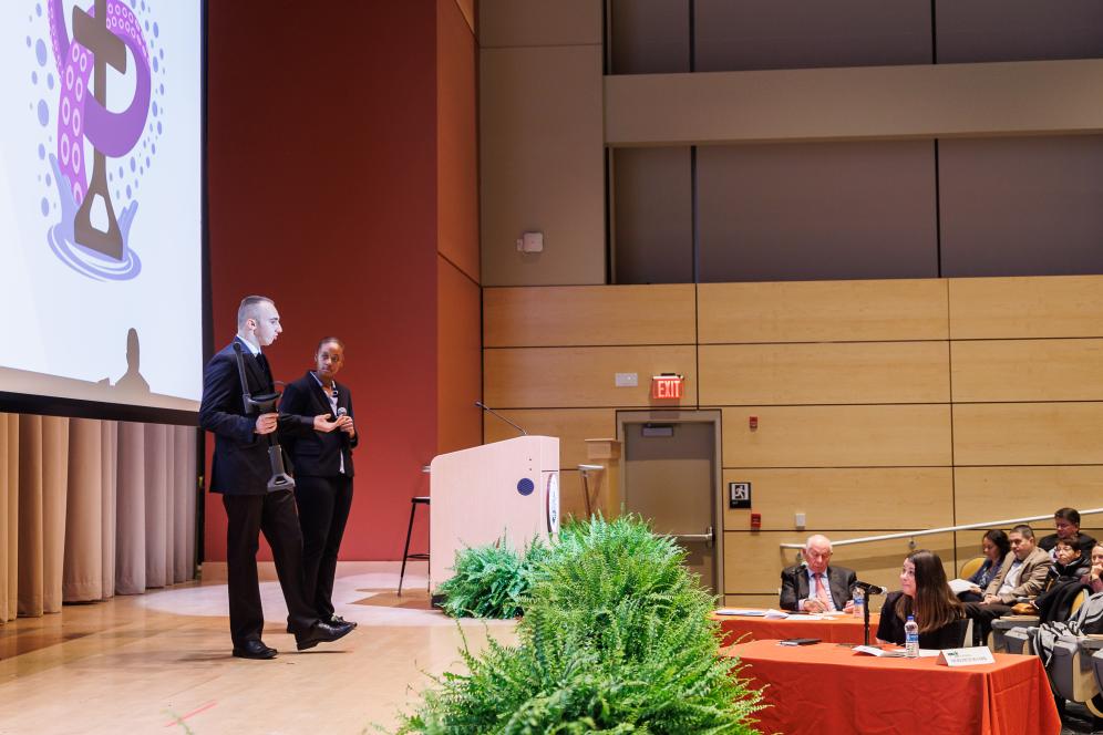 SparkBowl presenters are on stage presenting their business.