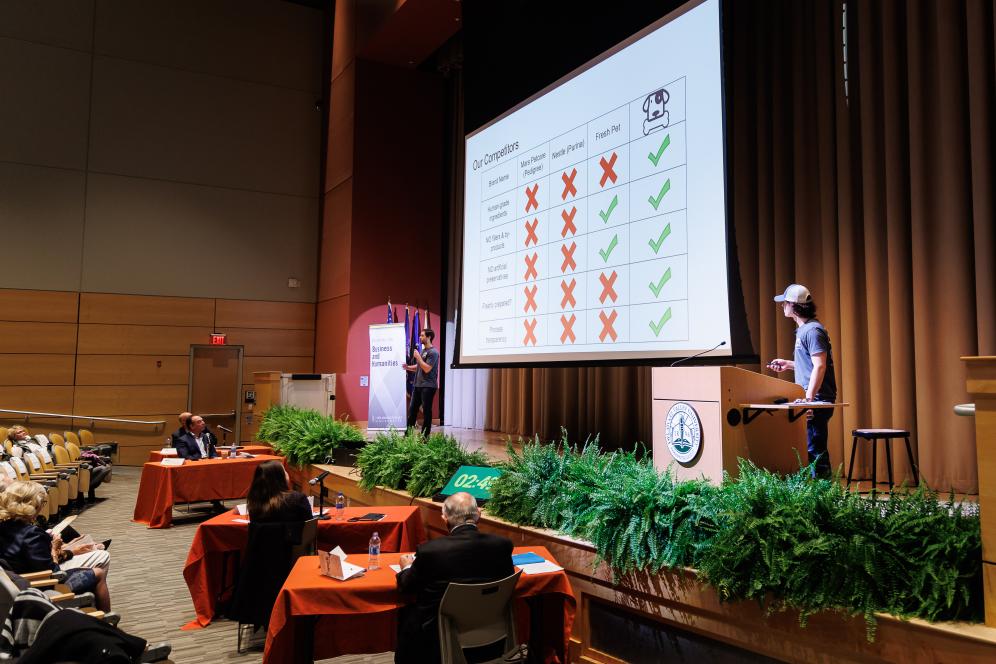 SparkBowl presenters are on stage presenting their business.