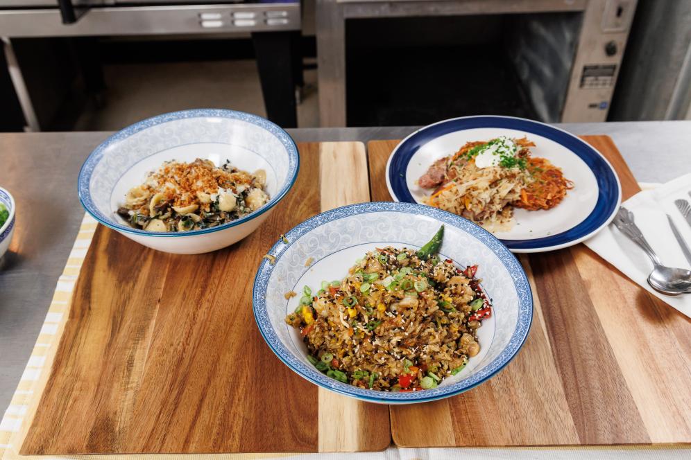 Orecchiette with Mushroom and Kale Sauce, Potato Cakes with Sausage, and Shrimp Fried Rice, made by Lee Chizmar and Alan Volant ’24 