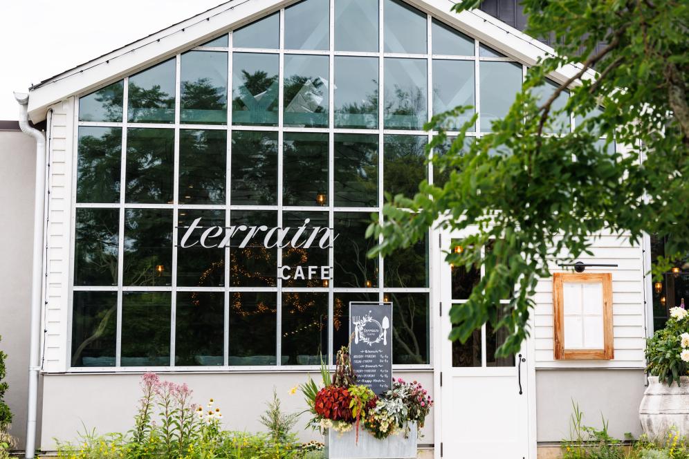 The outside window of Terrain Cafe with terrain signage. 