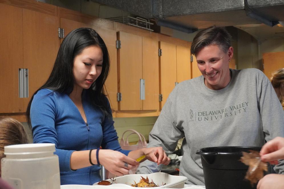 Emily Basile is with students in the wet lab, where students are running tests on leaves. 