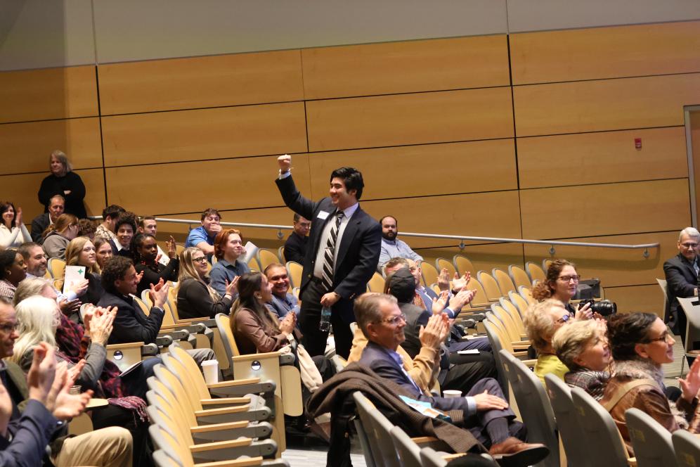 2025 Third Place winner Brian Haniff '26 is waving to the crowd from his seat in LSB. 