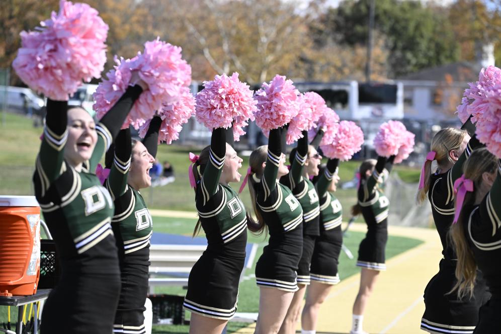 The DelVal Cheer Team in 2025, a group with poms poms in the air.