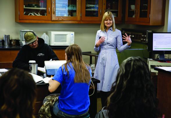 Professor teaching in a small classroom lab