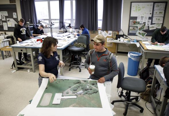 professor and student discuss 3D landscape model