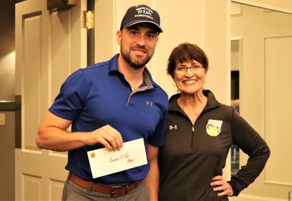 An alumni with a staff member at the golf outing.