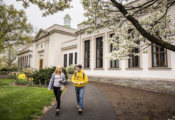Two students walking away from the library.
