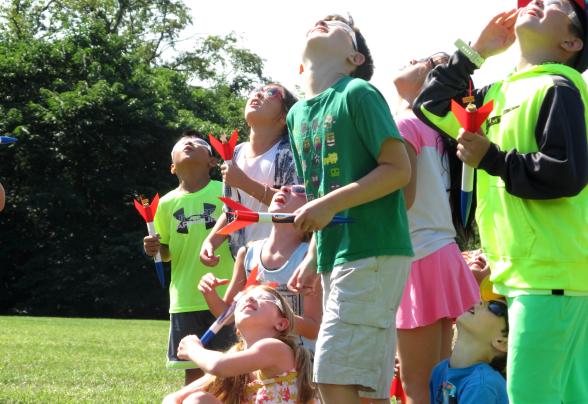 A group of kids look to the sky during a Space Rocket Blast 