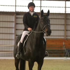 Student riding in dressage competition