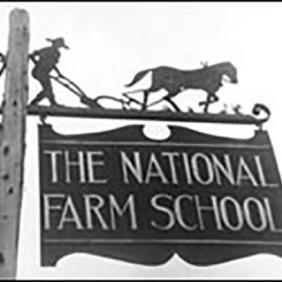 Very old photo of the Farm School sign.