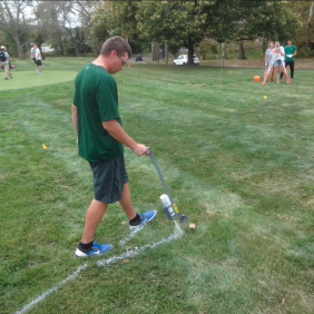 Students working outside on turf fields