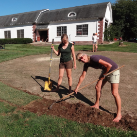 three student laying sod