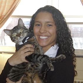 a college-age student holding a cat