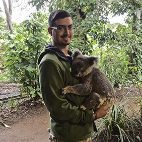 College-aged student holding a koala