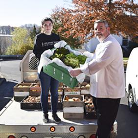 A student delivering DVU produce to a restaurant