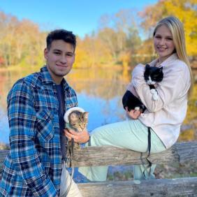 Students holding cats