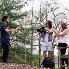 Marion Callahan and Media and Communication Students are outdoors filming.