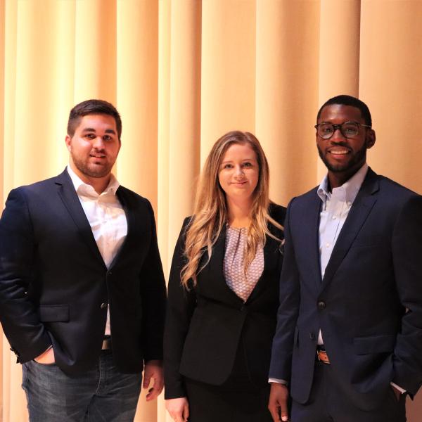 Three students in business casual wear. 