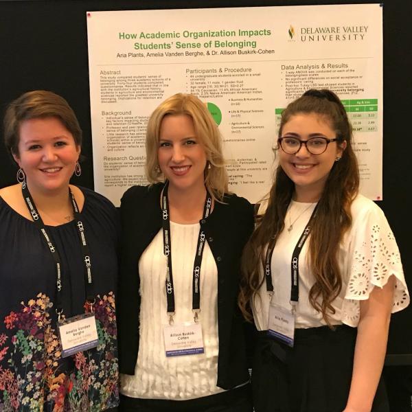 Two students and Dr. Cohen at a conference