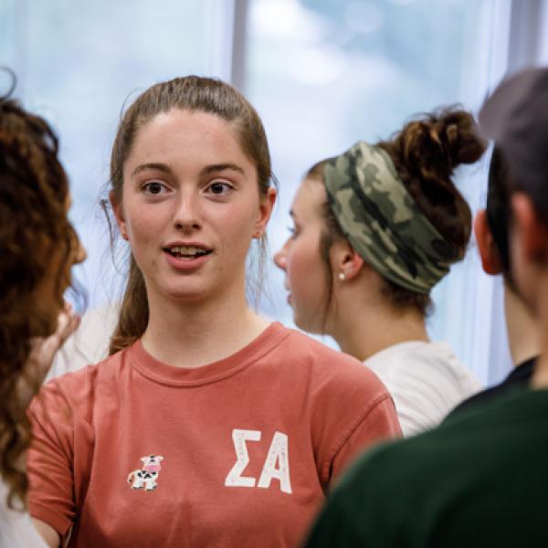 A student wearing a shirt with Greek letters signifying SIgma Alpha